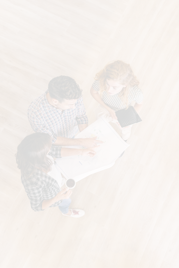 Creative architects on casual meeting reviewing blueprints standing on a wooden floor. Top view.